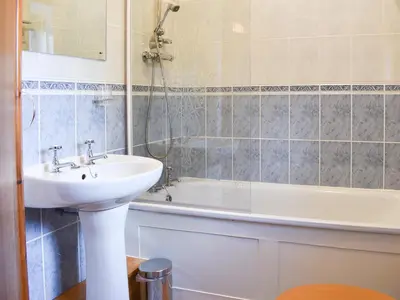 a bathroom with a sink and a bath tub at Linhay - Ukc4242 in Lanreath