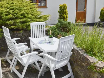 three white chairs and a table with a bottle of wine at Linhay - Ukc4242 in Lanreath