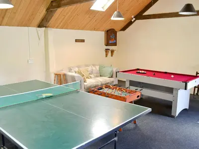 a room with a ping pong table and a couch at Linhay - Ukc4242 in Lanreath