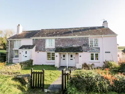 a white house with a fence in front of it at 4 Rose Cottages in Looe