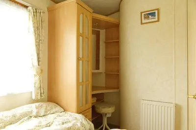 a bedroom with a bed and a book shelf at Coosewartha Countryside Holiday Rental in Truro
