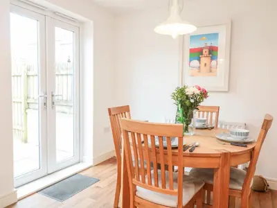 a dining room with a wooden table and chairs at Ripple in Bodmin