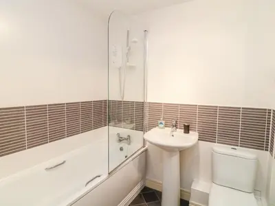 a bathroom with a sink and a toilet and a shower at Ripple in Bodmin