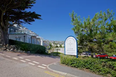 a sign in front of a building with a street at Compass Point in Carbis Bay