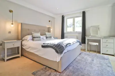 a bedroom with a large bed and a window at CLOSE TO BEACH, dogs welcome, private garden in St Merryn