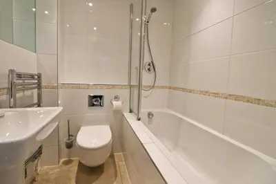 a bathroom with a toilet and a tub and a sink at CLOSE TO BEACH, dogs welcome, private garden in St Merryn