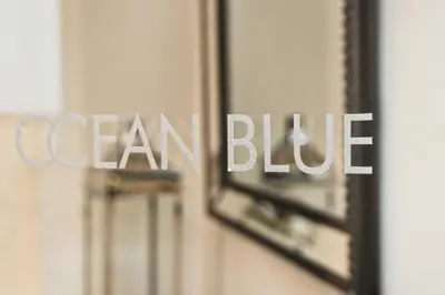 a sign that says ocean blue in front of a mirror at APARTMENT BY THE BEACH The Foxcove in St Merryn