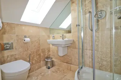 a bathroom with a toilet and a sink and a shower at 50m FROM THE BEACH, dogs welcome in St Merryn