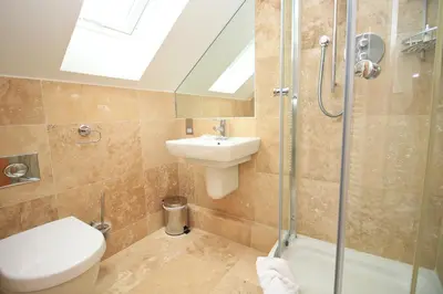 a bathroom with a toilet and a sink and a shower at 50m FROM THE BEACH, dogs welcome in St Merryn
