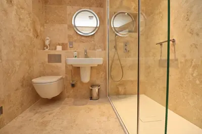 a bathroom with a shower and a toilet and a sink at BY THE BEACH, spacious apartment in St Merryn
