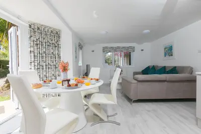 a white table and chairs in a living room at Lamorna in St Ives
