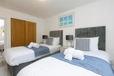 two beds sitting next to each other in a bedroom at Lamorna in St Ives
