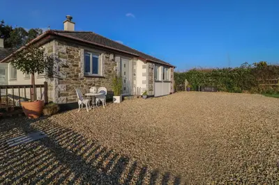 a house with a gravel driveway in front of it at Valley View in St Austell