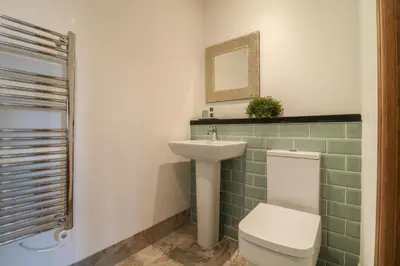 a bathroom with a toilet and a sink at Valley View in St Austell