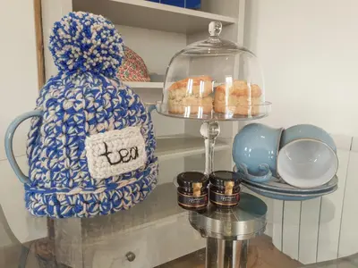 a shelf with a jar of donuts and a plate of food at Valley View in St Austell
