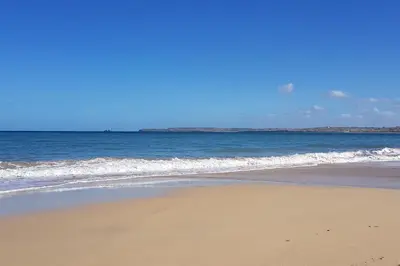 a sandy beach with the ocean in the background at Hillside Studio in Penzance