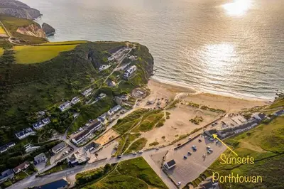 an aerial view of a beach and the ocean at Sunsets In Porthtowan, Beachfront apartment in Porthtowan