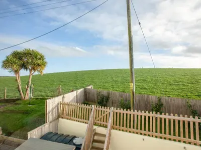 a view of a field from the balcony of a house at The White House in Poundstock