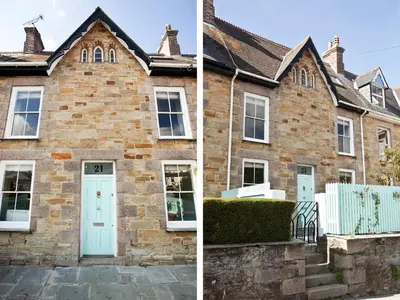 an old brick house with a blue door at 21 British Road in St. Agnes