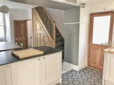 a kitchen with a counter top and a staircase at 21 British Road in St. Agnes