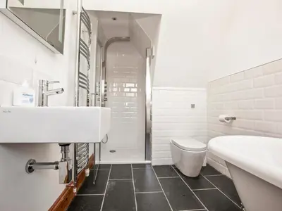 a white bathroom with a sink and a toilet at 21 British Road in St. Agnes