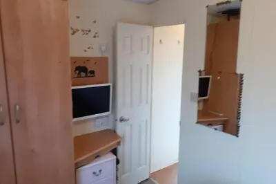 a small room with a television and a refrigerator at Kimberley Lane Static, Cornwall in Gwennap