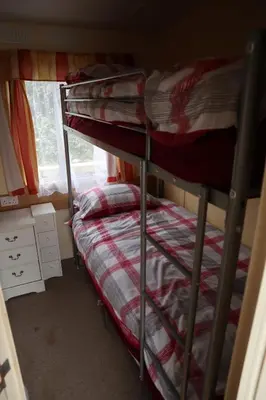 two bunk beds in a room with a window at Kimberley Lane Static, Cornwall in Gwennap