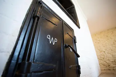 a black door with the letter xp written on it at The Old Bakery in Falmouth