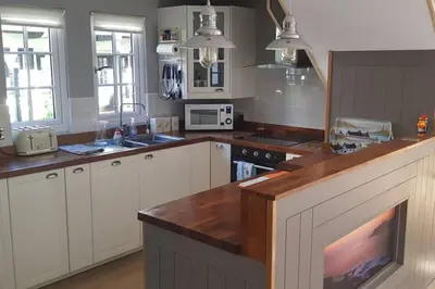 a kitchen with white cabinets and a counter top at 20 Tudor Court 