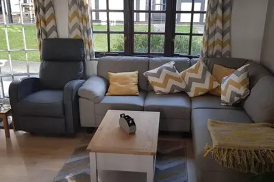 a living room with a couch and a coffee table at 20 Tudor Court 