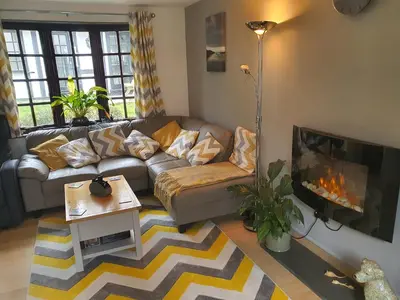 a living room with a couch and a fireplace at 20 Tudor Court 