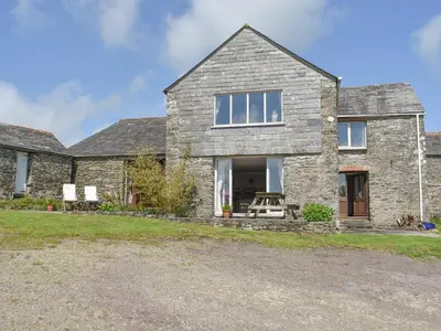 a stone house with a gravel driveway at The Owl's Roost - Uk12087 in Saint Endellion
