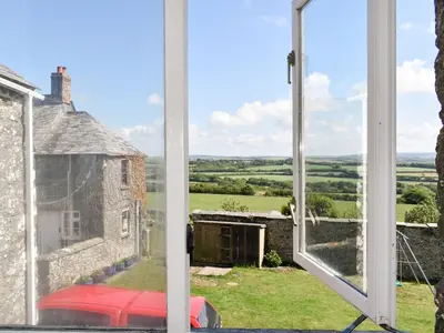 a view from a window of an old building at The Owl's Roost - Uk12087 in Saint Endellion