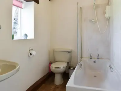 a bathroom with a toilet and a tub and a sink at The Owl's Roost - Uk12087 in Saint Endellion