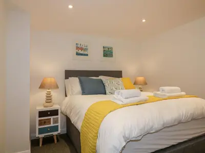 a bedroom with a bed with towels on it at The Crows Nest in St Austell