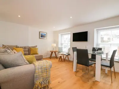 a living room with a couch and a table at The Crows Nest in St Austell
