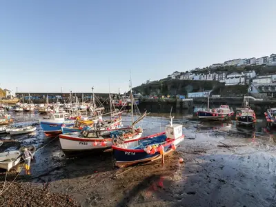a group of boats docked in a harbor at The Crows Nest in St Austell