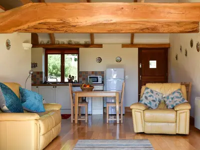 a kitchen with two chairs and a table in a room at Round House - Uk12083 in Saint Endellion