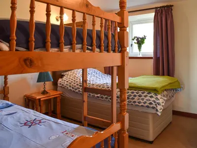 a bedroom with a bunk bed and a bunk bed at Swallows Nest - Uk12085 in Saint Endellion