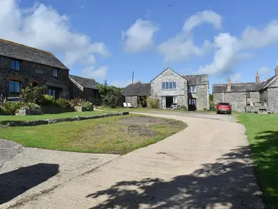 a driveway leading to a house with a red car at Swallows Nest - Uk12085 in Saint Endellion