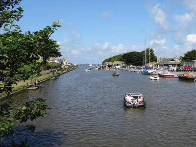 a group of people in a boat on a river at Penfound Country Cottage in Poundstock