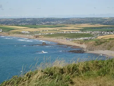 a view of a beach from a hill at Penfound Country Cottage in Poundstock