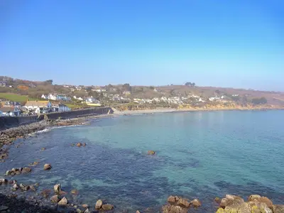 a view of a beach with rocks in the water at Chynoweth in Saint Keverne