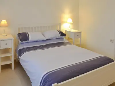 a bedroom with a large bed with two night stands at Chynoweth in Saint Keverne