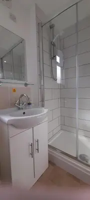 a bathroom with a sink and a shower and a tub at Woodland Retreat in Uny Lelant