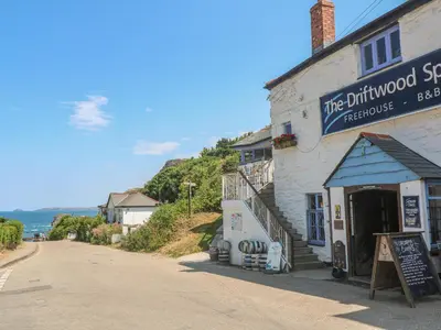 a building with a sign on it on a street at Avalon in St. Agnes