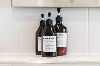three bottles of wine sitting on a shelf at Harbour View House in St Ives
