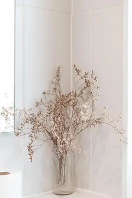 a vase with flowers in it on a table at Harbour View House in St Ives