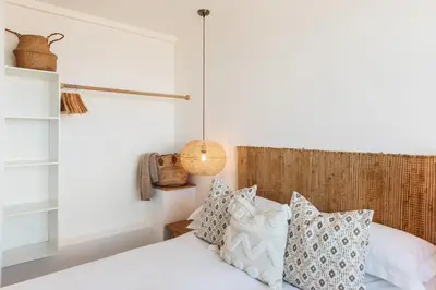 a bedroom with two beds with pillows and a lamp at Harbour View House in St Ives