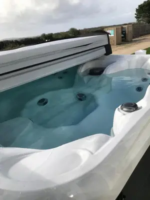 a jacuzzi tub with a window on top of it at Valley View with a luxurious hot tub in Newquay